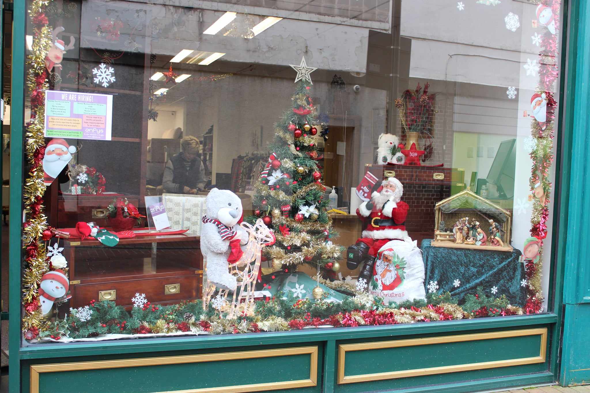 Enfys shop window with Christmas tree, santa and snowman, with christmas decorations around