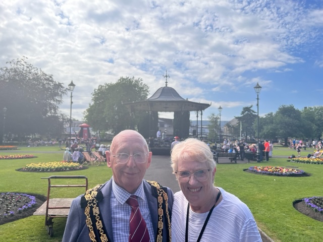 The Mayor and Mayoress in Victoria Gardens with the bandstand in the background